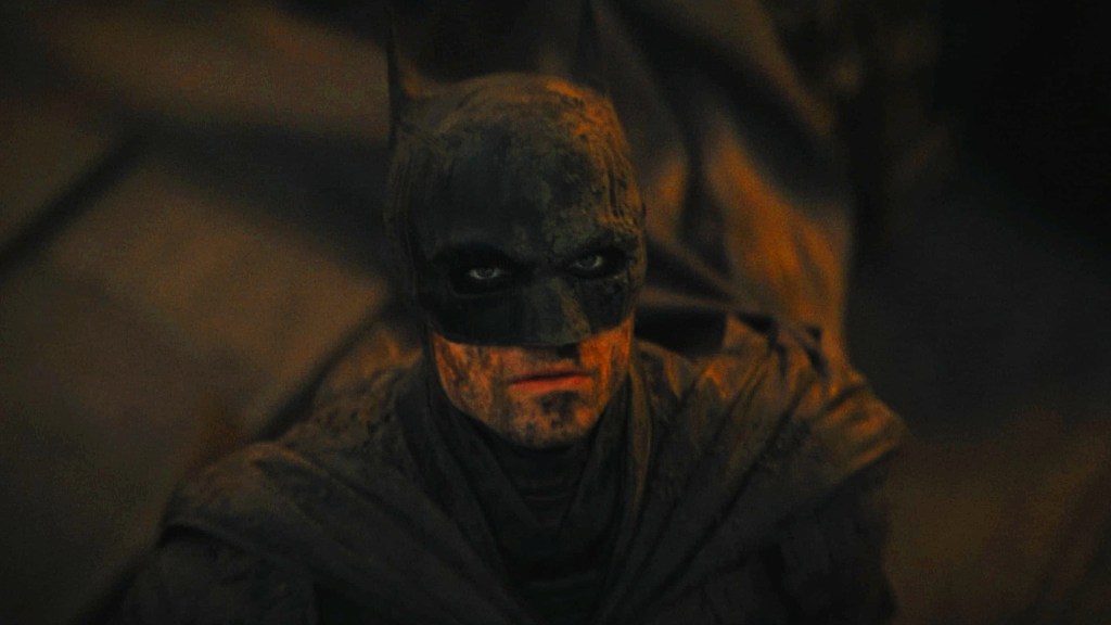 Robert Pattinson as Batman looking up in The Batman